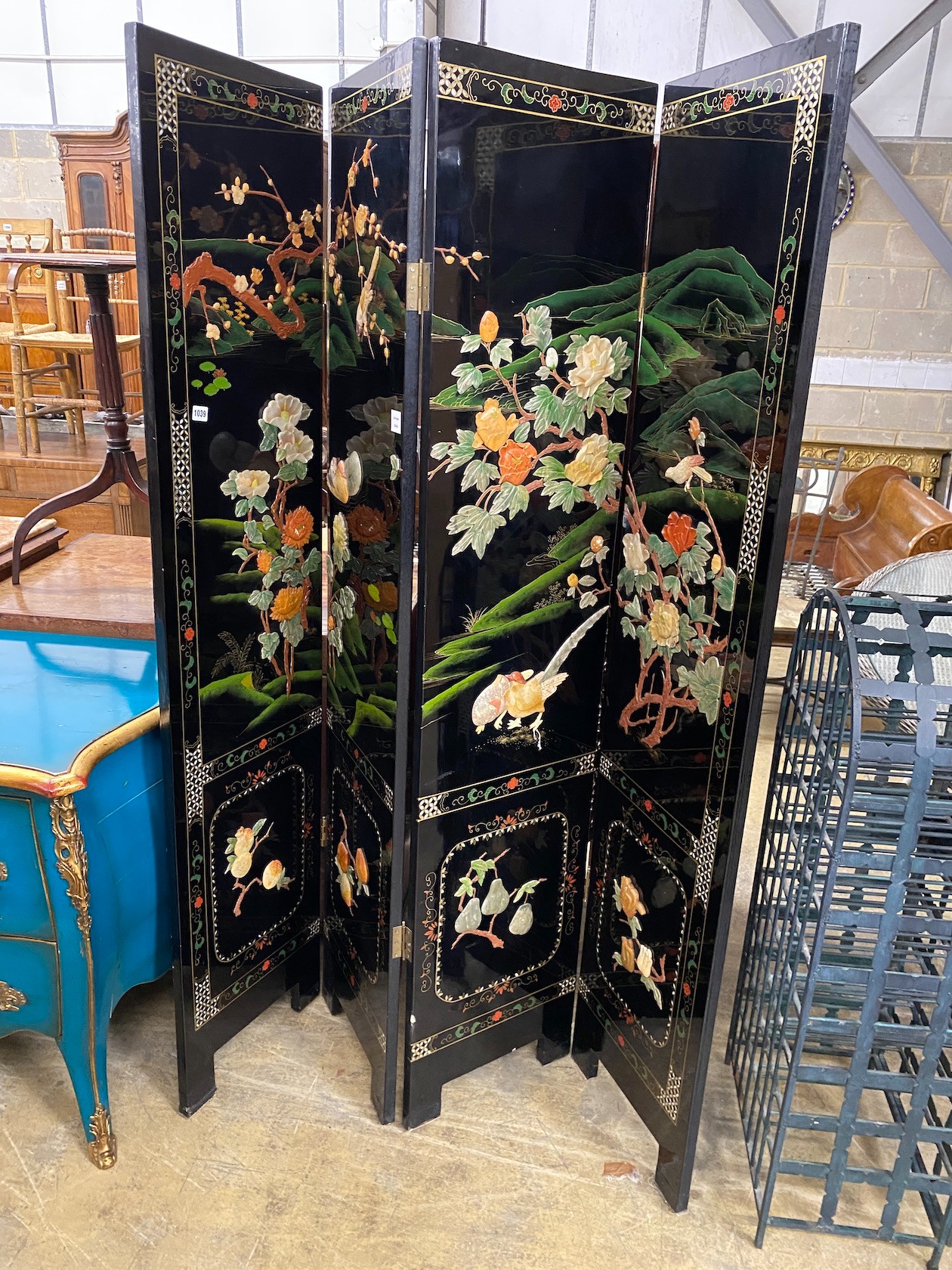 A Chinese black lacquer four fold dressing screen, each panel width 40cm, height 185cm